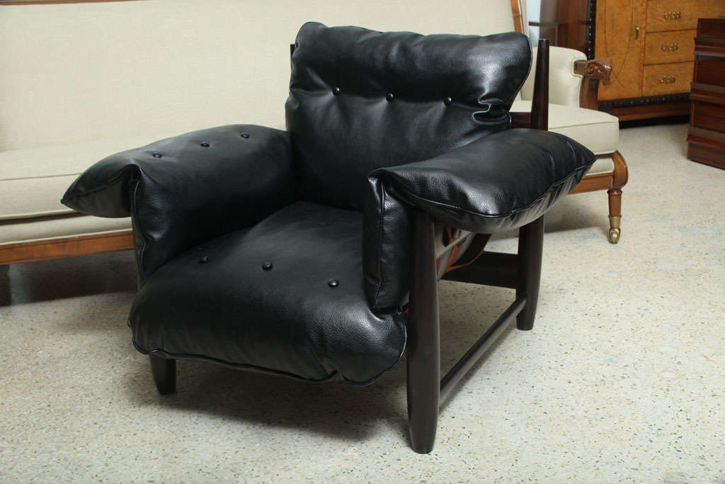 Rosewood frames with leather bottom straps supporting deep side back and bottom  cushions characterize these club chairs by Sergio Rodriguez. The frames have unique, tapered corner posts. Purchased from Mr. Rodrigues in 2001